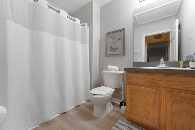 bathroom with wood-type flooring, vanity, and toilet