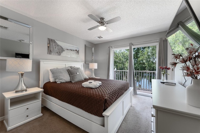 bedroom with dark colored carpet, access to outside, ceiling fan, and a textured ceiling