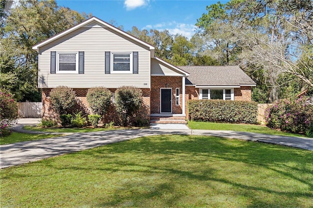 tri-level home with a front yard