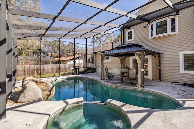 view of swimming pool featuring an in ground hot tub, glass enclosure, and a patio