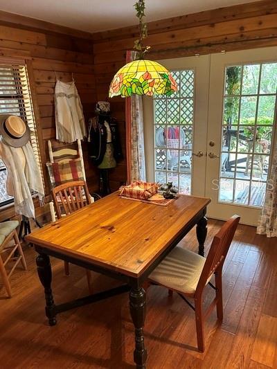 dining area featuring wood-type flooring and french doors