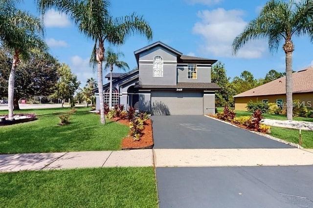 view of front facade with a garage and a front lawn