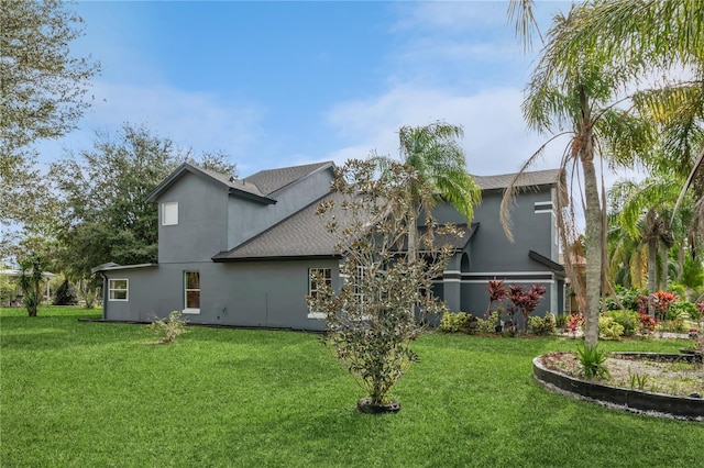 rear view of house featuring a yard