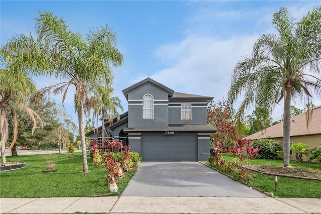 view of property featuring a garage and a front lawn