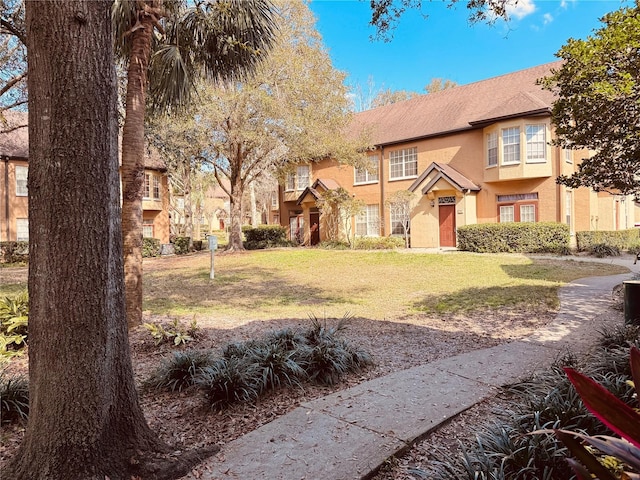 tudor-style house with a front lawn