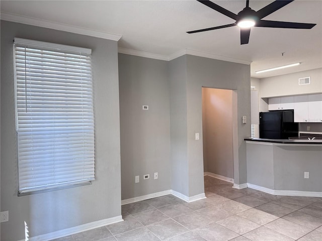 kitchen with white cabinetry, crown molding, light tile patterned floors, black refrigerator, and ceiling fan