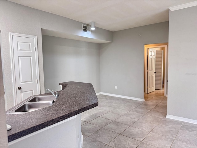 kitchen featuring sink and light tile patterned floors