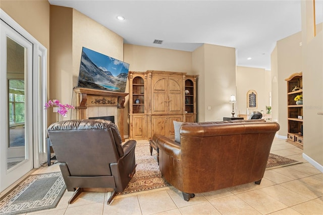 tiled living room with a tiled fireplace