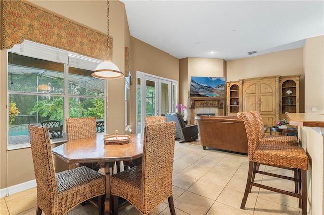 tiled dining area featuring a tiled fireplace