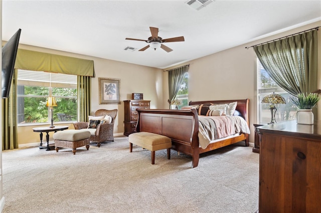 bedroom featuring light colored carpet and ceiling fan