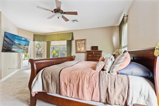 carpeted bedroom with ceiling fan and access to outside