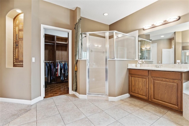 bathroom with tile patterned floors, vanity, and an enclosed shower