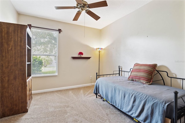 bedroom with light colored carpet and ceiling fan