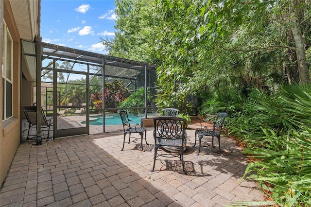 view of patio / terrace featuring glass enclosure