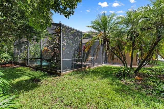 view of yard with glass enclosure