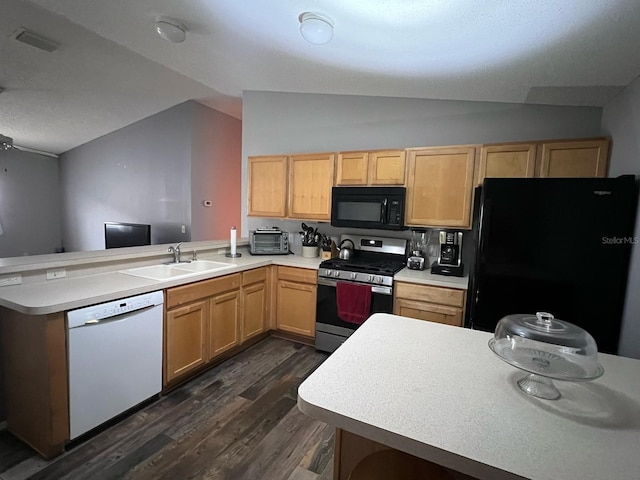 kitchen featuring sink, vaulted ceiling, light brown cabinets, kitchen peninsula, and black appliances