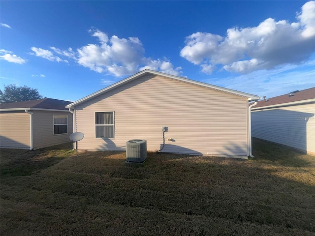 view of property exterior with cooling unit and a yard