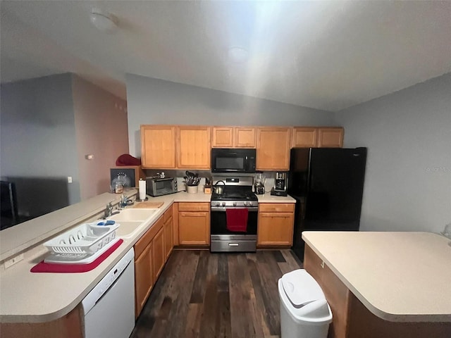 kitchen with vaulted ceiling, dark hardwood / wood-style floors, black appliances, sink, and kitchen peninsula