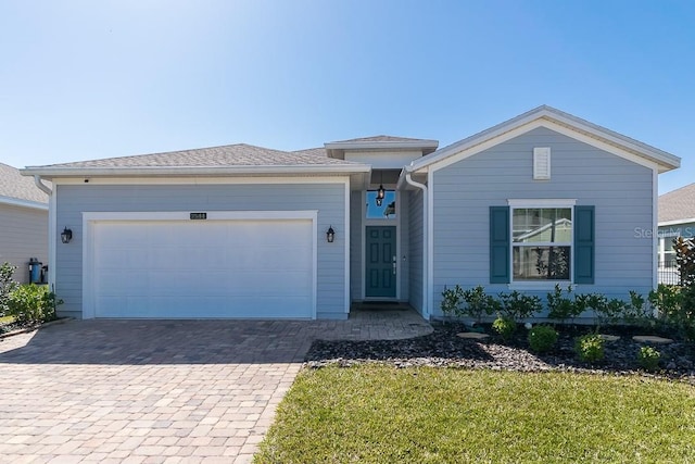 view of front of house featuring a garage and a front lawn