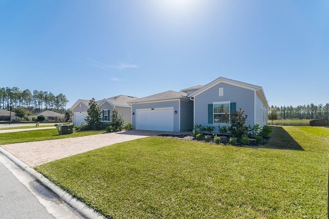 7544 Rock Brook Dr, Jacksonville, FL 32222 - ranch-style house with driveway, an attached garage, and a front yard