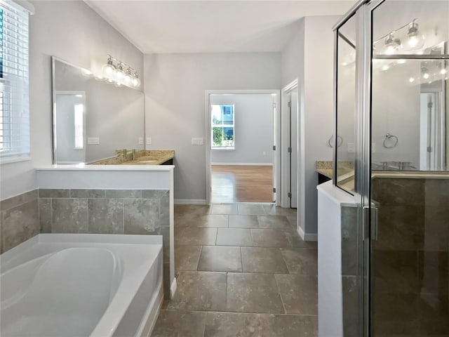 bathroom with independent shower and bath and vanity