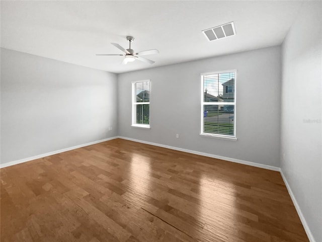 spare room with hardwood / wood-style flooring and ceiling fan