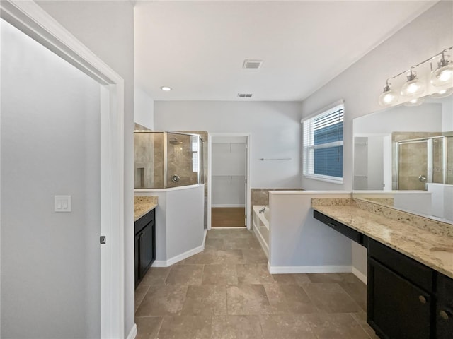 bathroom featuring vanity and separate shower and tub