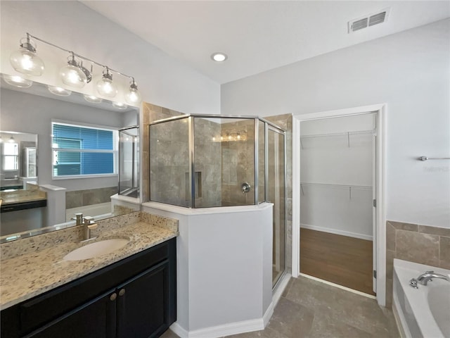 bathroom with independent shower and bath and vanity