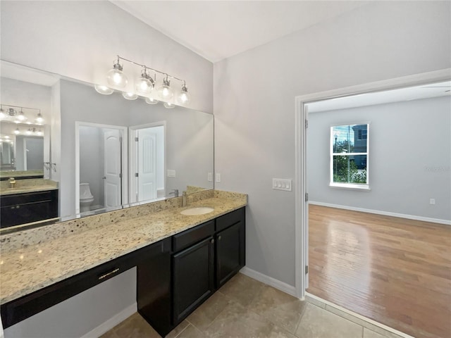 bathroom featuring vanity, toilet, and tile patterned flooring