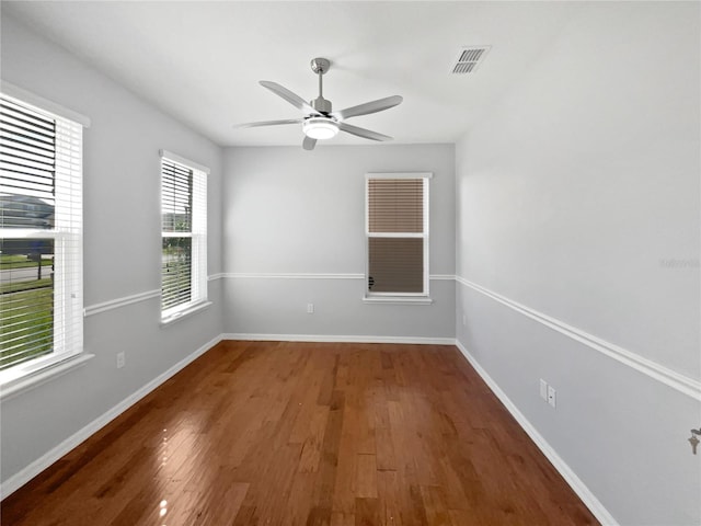 spare room featuring dark hardwood / wood-style floors and ceiling fan