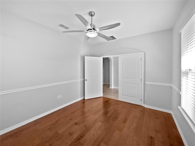 unfurnished bedroom with ceiling fan and hardwood / wood-style floors