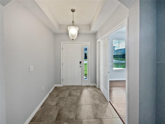 foyer entrance featuring a raised ceiling