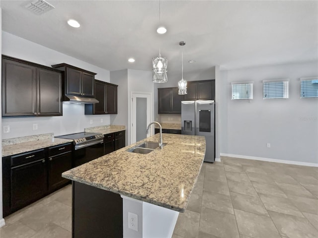 kitchen with sink, hanging light fixtures, a kitchen island with sink, dark brown cabinetry, and stainless steel appliances