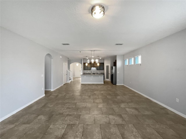 unfurnished living room with a textured ceiling