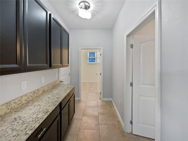 hall with light tile patterned floors