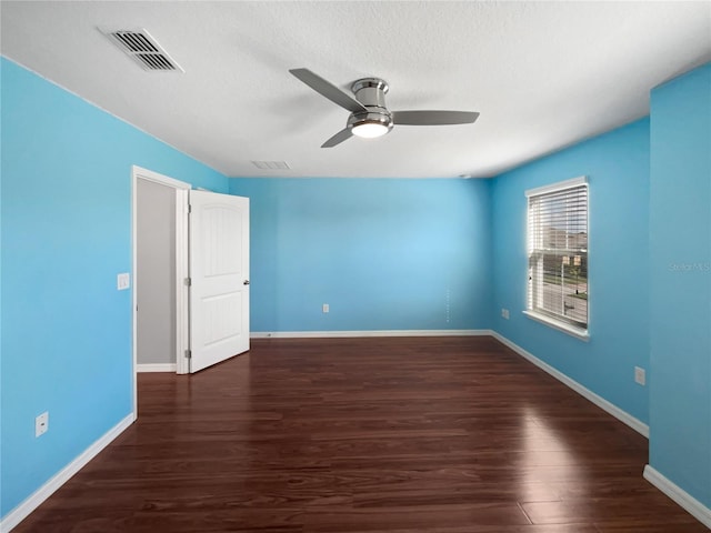 unfurnished bedroom with ceiling fan, dark wood-type flooring, and a textured ceiling