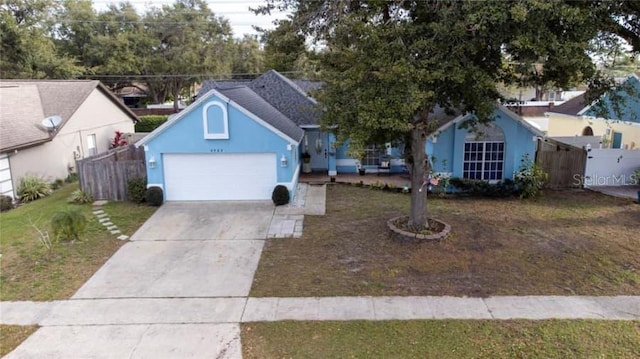 view of front facade featuring a garage and a front lawn