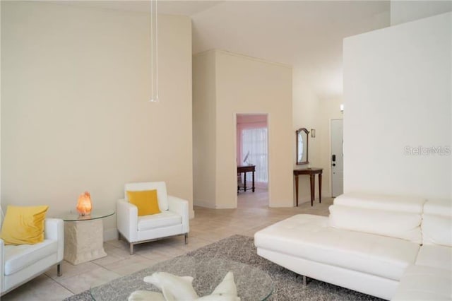 living room with light tile patterned flooring and high vaulted ceiling