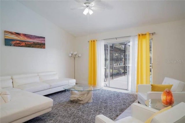 living room featuring ceiling fan and vaulted ceiling