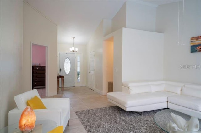 tiled living room featuring a chandelier