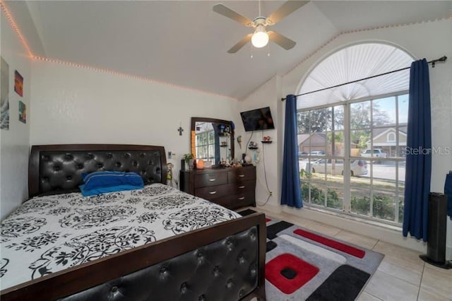 bedroom with light tile patterned floors, vaulted ceiling, and ceiling fan