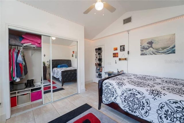 tiled bedroom with lofted ceiling, a closet, and ceiling fan