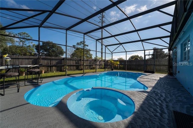 view of swimming pool with an in ground hot tub, a patio, and glass enclosure