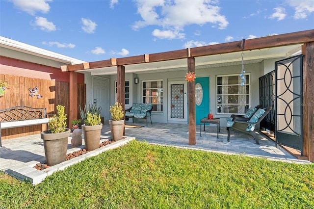 back of property featuring a yard and covered porch