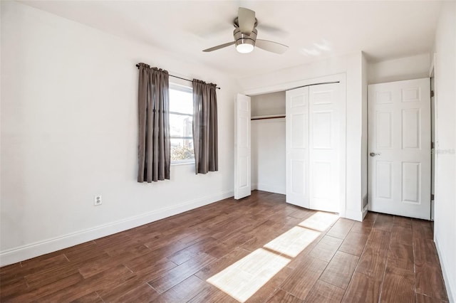 unfurnished bedroom with dark wood-type flooring, a closet, and ceiling fan