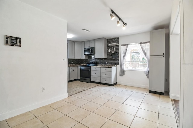 kitchen with light tile patterned flooring, gray cabinetry, decorative backsplash, and electric stove