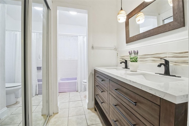 full bathroom featuring shower / tub combo with curtain, tile patterned floors, toilet, and vanity