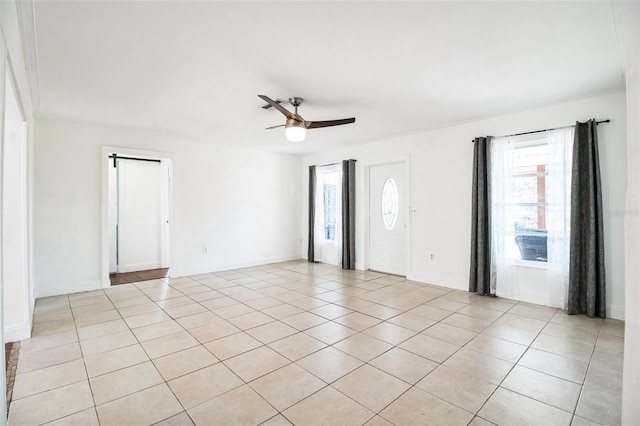 spare room featuring light tile patterned flooring and ceiling fan