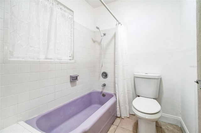 bathroom featuring tile patterned flooring, shower / bath combination with curtain, and toilet