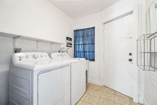 laundry room featuring light tile patterned floors and independent washer and dryer